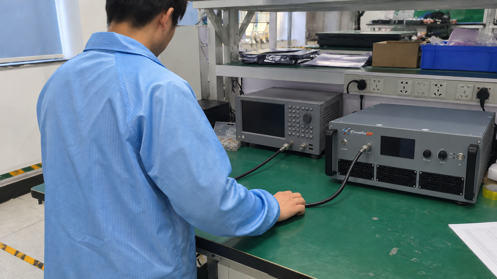A technician preparing a coaxial connection between an RF instrument and a CorelixRF rack amplifier.
