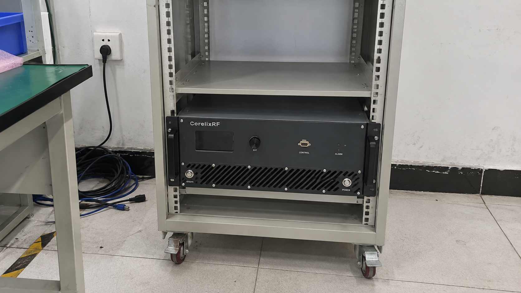 CorelixRF rack amplifier supported in a plain equipment rack with an empty bay above it.