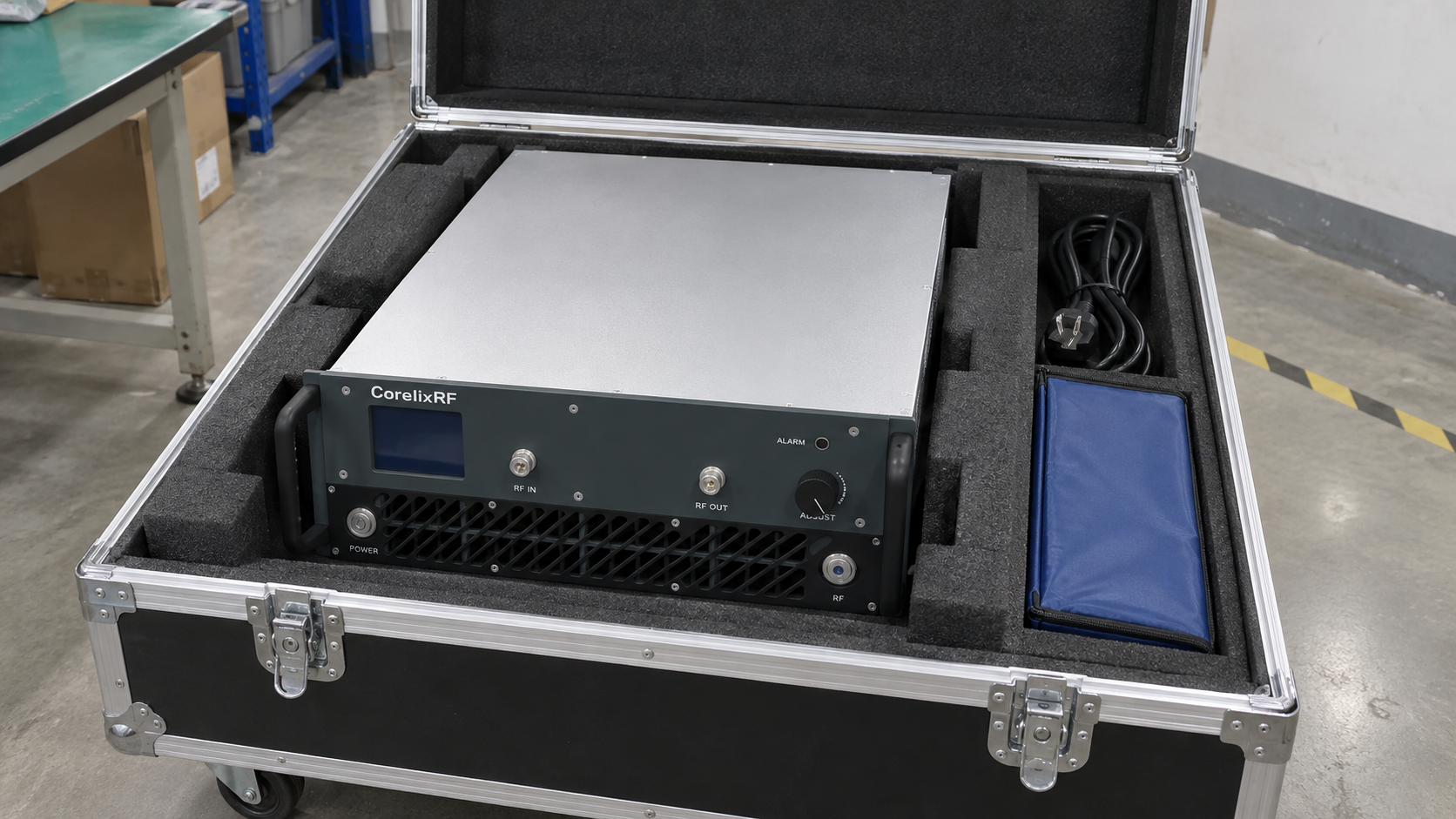 A rack amplifier resting in a fitted protective transport case with a separate document pouch.