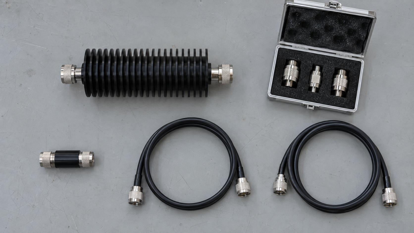 Overhead arrangement of RF attenuators, coaxial leads and a case of coaxial accessories.