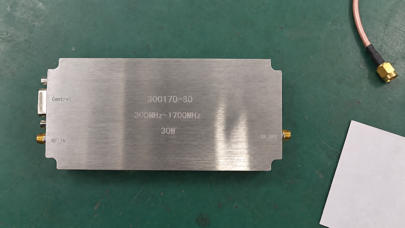 Compact RF amplifier module resting on an antistatic work mat.