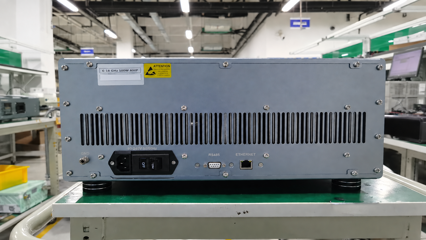 Rear panel of a rack amplifier with ventilation slots, power inlet and control interfaces.