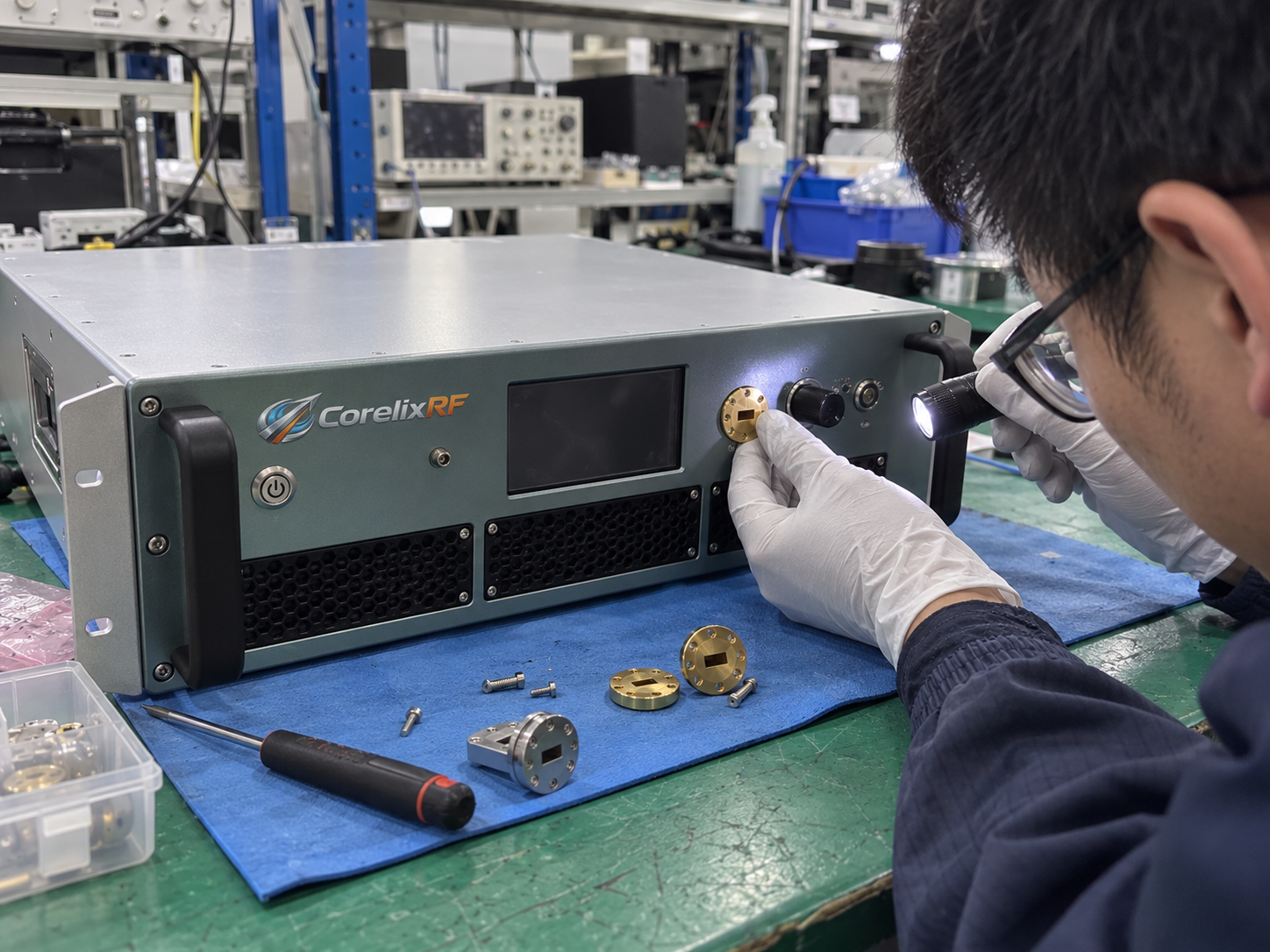Technicians inspect the front-panel RF and waveguide interfaces